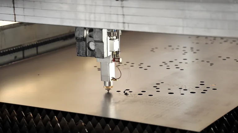Laser cutting head working on a metal sheet
